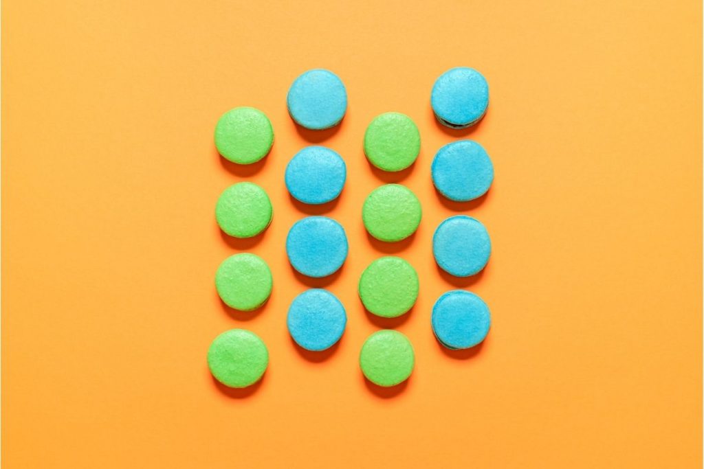 blue and green macaroons on an orange background