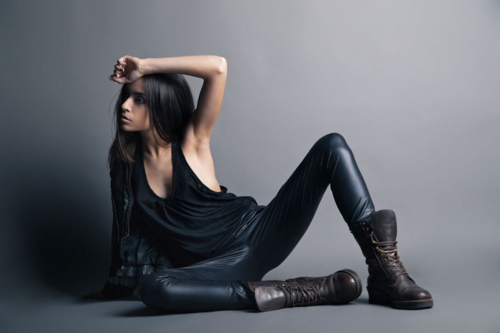 female model wearing leather pants posing