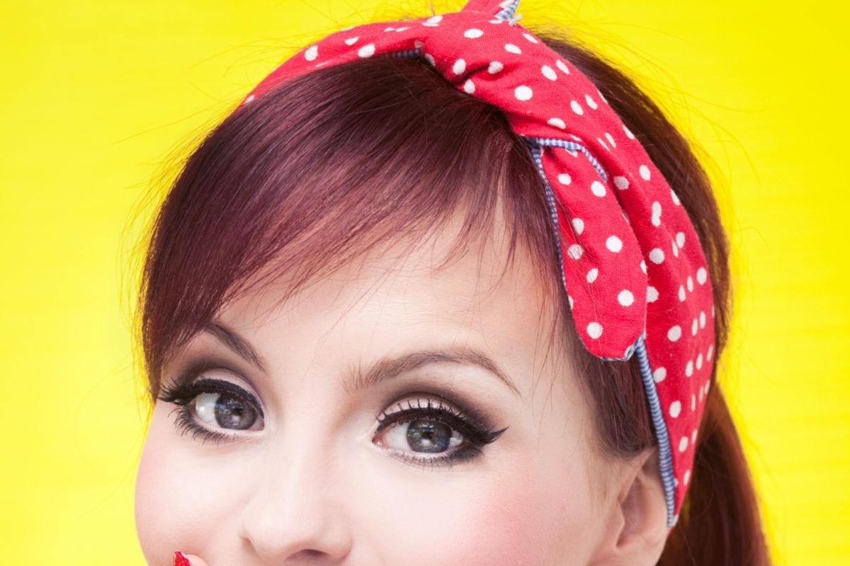 closeup of red headband with white polkadots on a greaser girl portrait