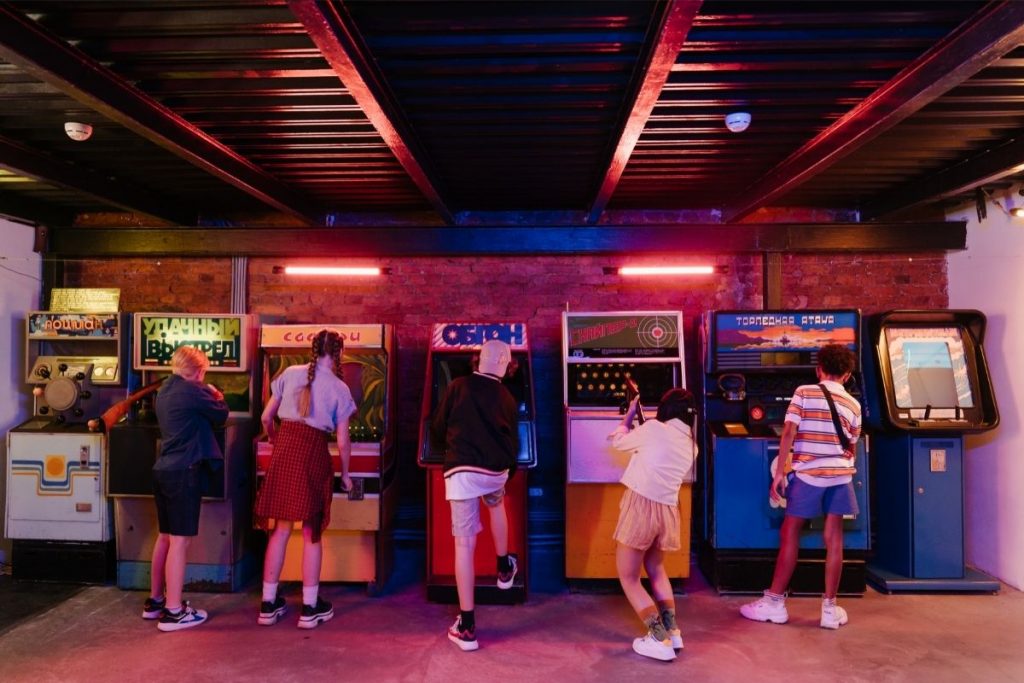 group of teenagers playing arcade