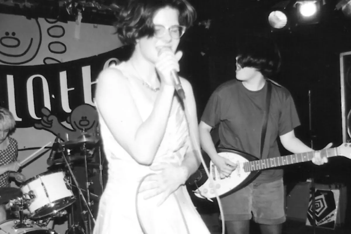 black and white photo of a woman singing on stage