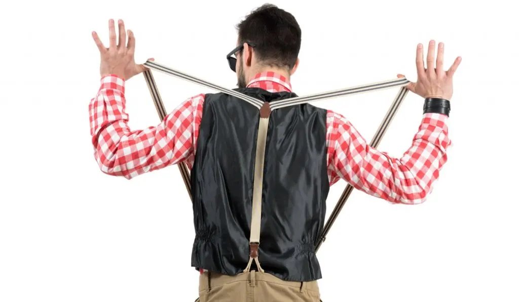 back view photo of a guy holding out his suspenders 