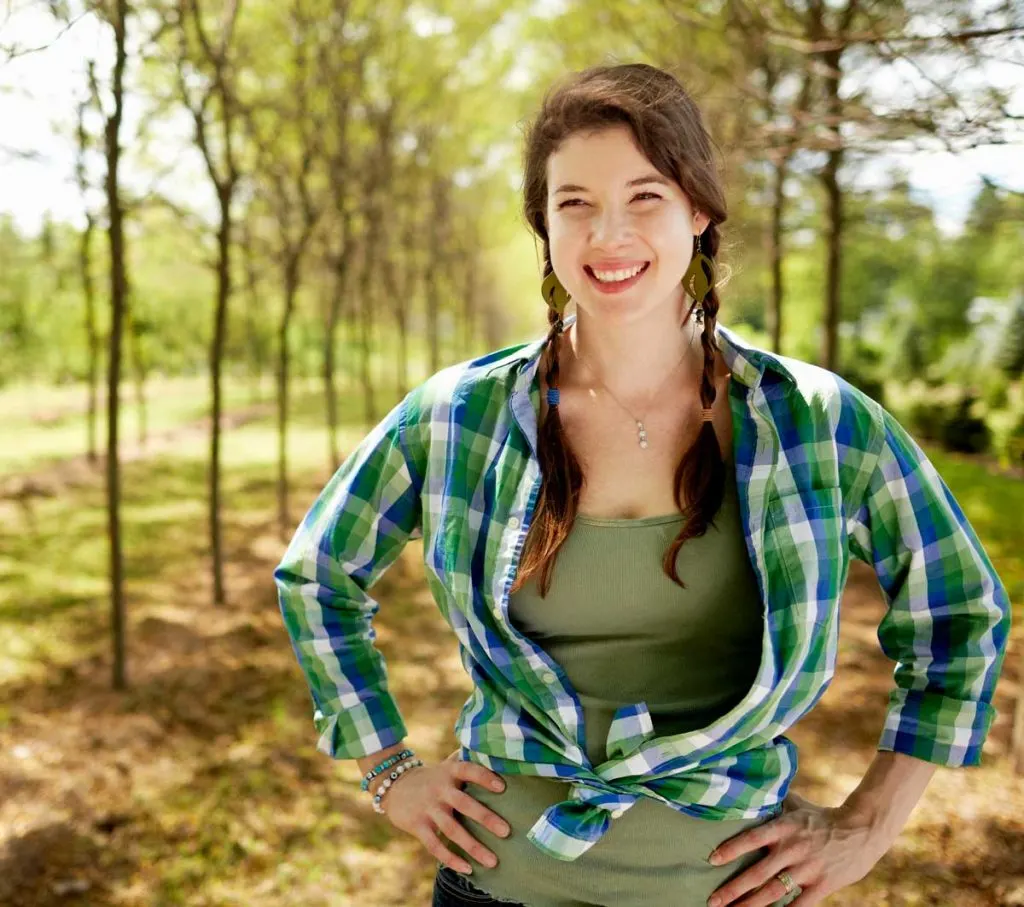 girl wearing blue and green plaid shirt with green tank top
