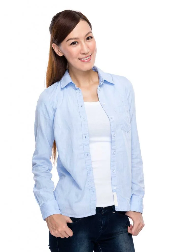 Asian woman wearing cute baby blue button up and very dark navy jeans