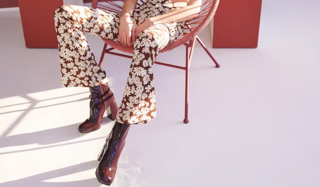 woman wearing platform shoes from the 70s and a flowery pants