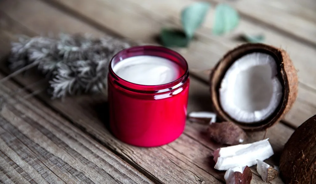 Organic cream on wooden background. Conditioner, shampoo for hair care.