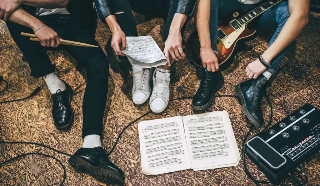 crop image of one rock music band with their instrument 