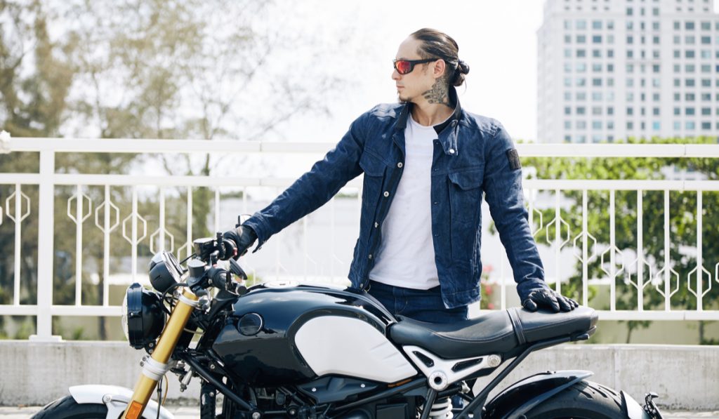 long hair man standing motorcyclist
