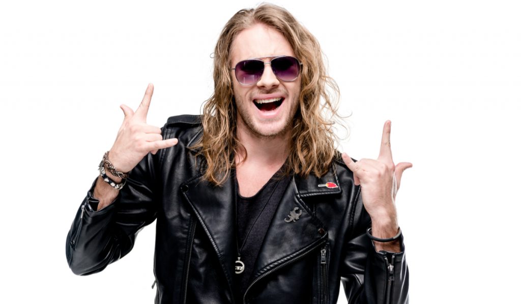 portrait of handsome rocker in black leather jacket and sunglasses 