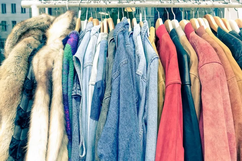 vintage second hand clothes hanging on a thrift store rack