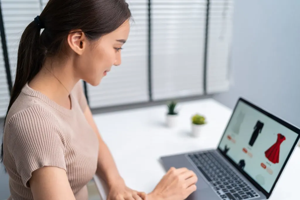 woman shopping for used clothes in an online thrift store