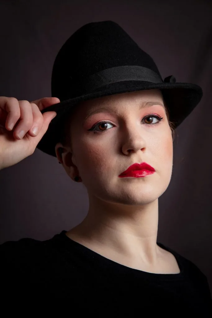 woman wearing black trilby hat