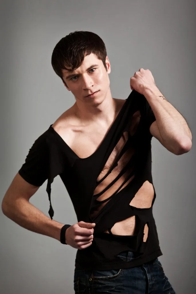 young man in black ripped clothing